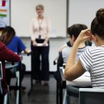 students-doing-the-exam-in-classroom-PEWSHFM-min