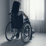 Sad woman sitting on wheelchair