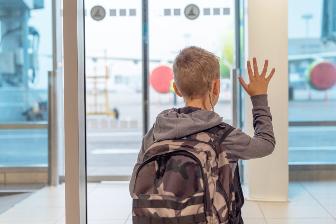 boy-at-airport-waiting-to-board-flight-with-hand-l-2026-01-11-08-52-06-utc